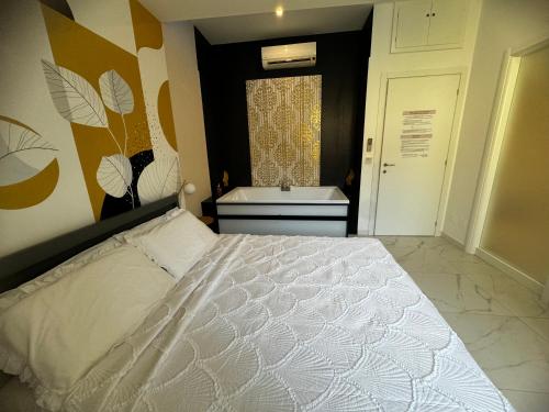 a bedroom with a white bed and a sink at Cagliari Love Suite in Cagliari