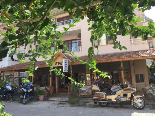 a building with motorcycles parked in front of it at Hotel Efes in Gumuldur