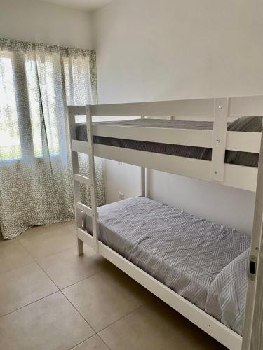 a bedroom with two bunk beds and a window at La Campanula-exclusive pool in Santa Maria a Monte