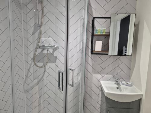 a bathroom with a shower and a sink at Dog-Friendly Basement Apartment with Garden - Southsea, Portsmouth #26a in Portsmouth