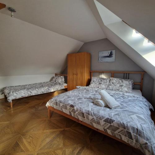 a bedroom with a bed in a attic at Bydlím U Arény in Nová Ves
