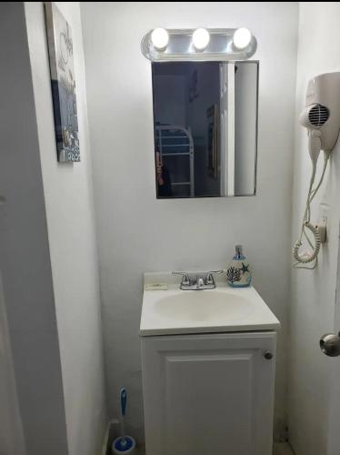 a bathroom with a white sink and a mirror at B3 Best Value on Private Bedroom with Private Bathroom in Little Havana, Miami in Miami