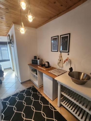a kitchen with a sink and a counter at Le Petit in Vredendal
