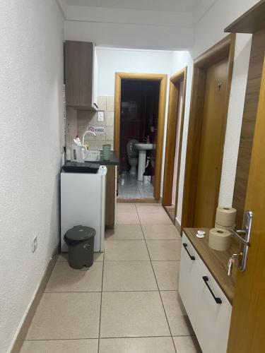 a kitchen with a hallway leading to a bathroom at SARAH APARTMENTS in Gusinje