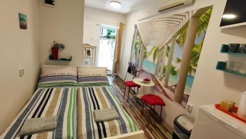a bedroom with a bed and a table and chairs at Center Rooms with terrace in Rijeka