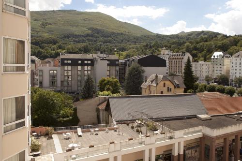a city with buildings and mountains in the background at Villa Mariale by Popinns in Lourdes