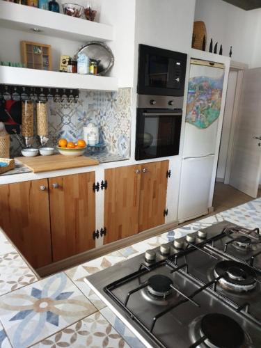 a kitchen with a stove and a stove top oven at Casa Giacomina in Perledo