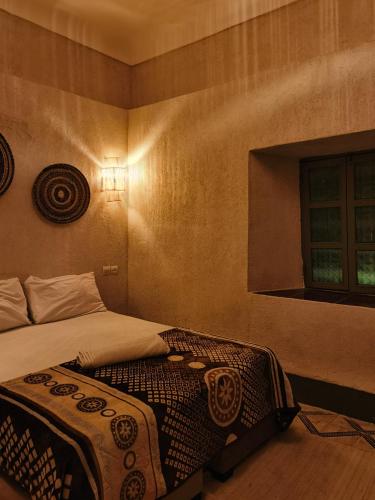 a bedroom with a bed and a window at Medina Oasis Hostel in Marrakesh