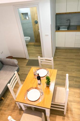 a table with two plates on it in a living room at Vila Anxhelo in Vlorë