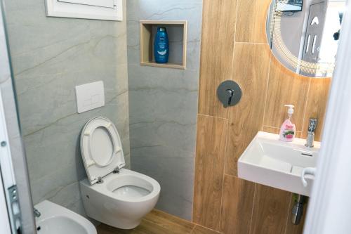 a bathroom with a toilet and a sink at Vila Anxhelo in Vlorë