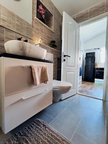 a bathroom with a sink and a toilet at Studio Apartment FortyOne in Orebić