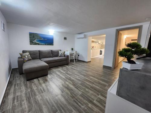 a living room with a couch and a table at Don Vito's Home, DsG2 Short Lets, 250 mt Metrò in Palermo