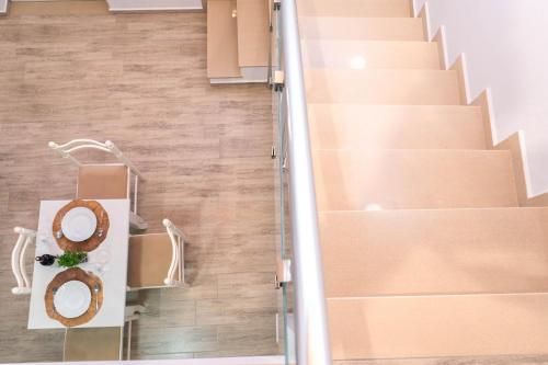 a room with stairs and a donut on a table at Vila Anxhelo in Vlorë