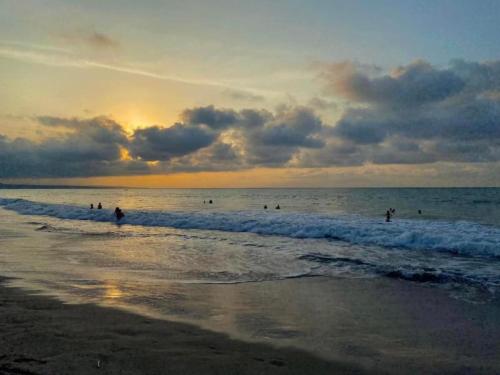 a group of people in the water at the beach at Jurado, Casa Hospedaje in Tonsupa