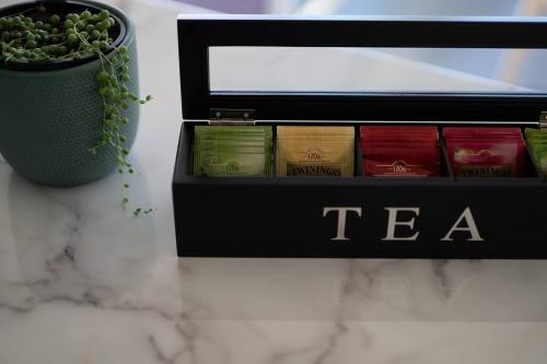 a box of tea sitting on a counter with a plant at Kalang BnB St Helens in St Helens