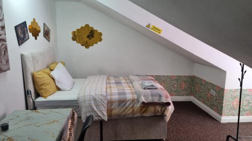 een kleine slaapkamer met een bed en een trap bij Flats By kingpower stadium in Leicester
