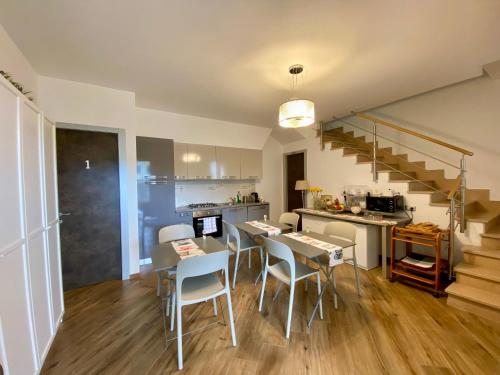 a kitchen and dining room with a table and chairs at Holiday Rooms La Campagnetta in Alassio