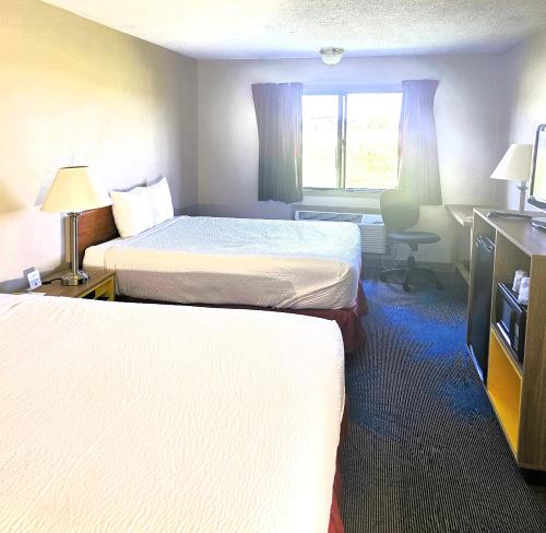 a hotel room with two beds and a window at Days Inn by Wyndham North Sioux City in North Sioux City