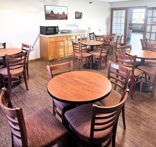 a dining room with wooden tables and chairs at Days Inn by Wyndham North Sioux City in North Sioux City
