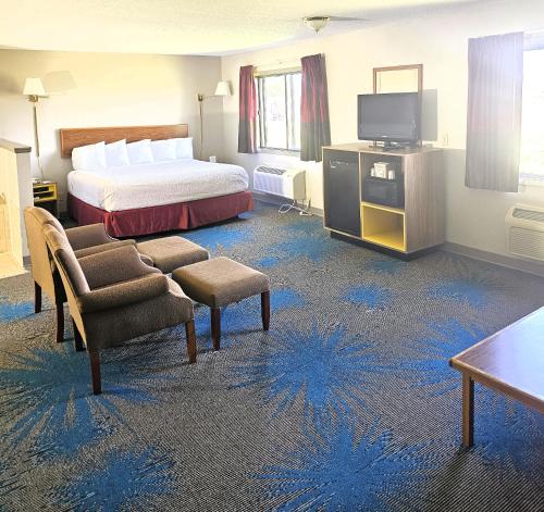 a hotel room with a bed and a television at Days Inn by Wyndham North Sioux City in North Sioux City