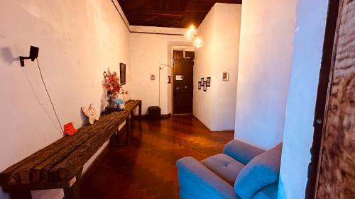a living room with a table and a blue couch at CASA DE LAS FLORES in Guatemala