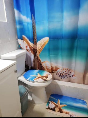 a bathroom with a toilet with a starfish shower curtain at B4 Best Value on Private Bedroom with Private Bathroom in Little Havana, Miami in Miami