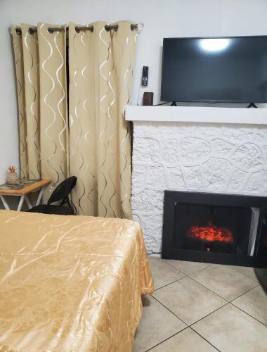 a bedroom with a fireplace with a tv above it at B4 Best Value on Private Bedroom with Private Bathroom in Little Havana, Miami in Miami