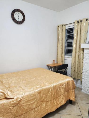 a bedroom with a bed and a clock on the wall at B4 Best Value on Private Bedroom with Private Bathroom in Little Havana, Miami in Miami