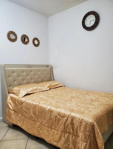 a bedroom with a bed and a clock on the wall at B4 Best Value on Private Bedroom with Private Bathroom in Little Havana, Miami in Miami