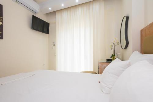 Ένα ή περισσότερα κρεβάτια σε δωμάτιο στο Le Monde SeaView Suites