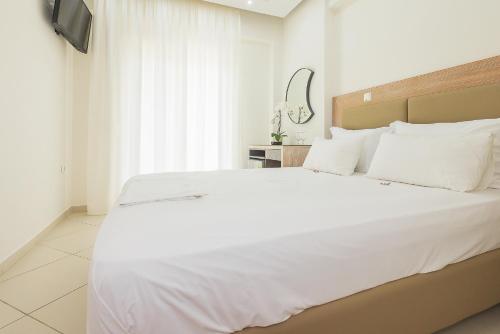 Ένα ή περισσότερα κρεβάτια σε δωμάτιο στο Le Monde SeaView Suites
