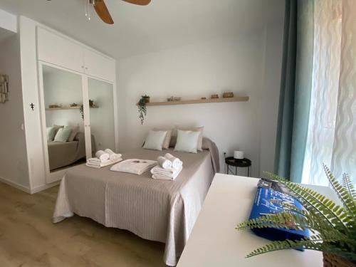 a bedroom with a bed with towels on it at Apartamentos Benal Beach Group in Benalmádena