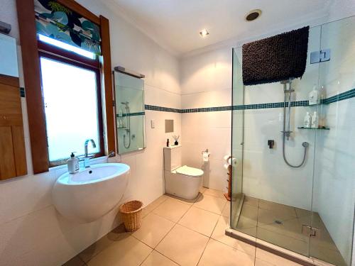 a bathroom with a sink and a shower and a toilet at Dog-friendly in Waterloo in Lower Hutt