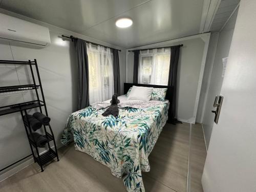 a small bedroom with a bed and a ladder at Villa Blessed and Hot Springs Free in Fortuna