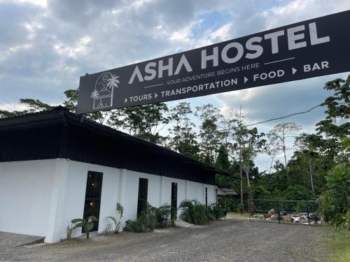 a building with a sign on top of it at Asha Hostel in Fortuna