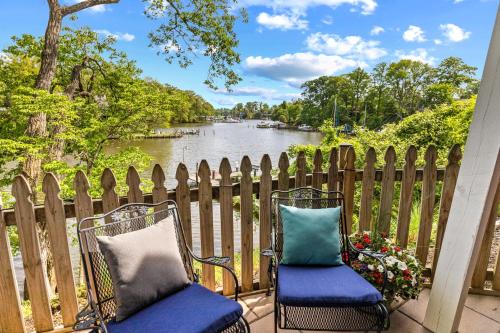 two chairs on a patio with a view of a river at Riverview Retreat On Warehouse Creek in Edgewater