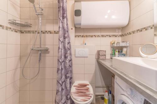 a bathroom with a shower and a toilet and a sink at Appt t2 cabine clim parking privée vu mer in Sète