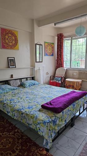 a bedroom with a large bed in a room at Laxmi Happy Home in Pune