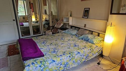 a bedroom with a bed and a lamp at Laxmi Happy Home in Pune