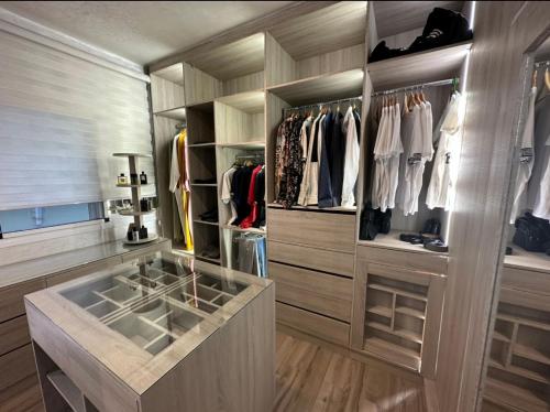 a walk in closet with a large glass display case at Villa Marina in Marina Smir