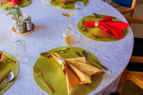 a table with two green plates of food on it at Amanya 1-Bed Leopard Tent in Amboseli