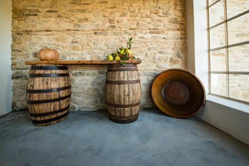 a table with fruit on top of two wooden barrels at Quinta da Eira Velha in Aldeia do Mato