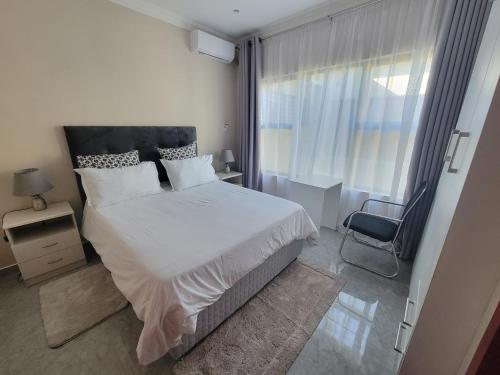 Ένα ή περισσότερα κρεβάτια σε δωμάτιο στο Sable Suites B2, 2 & 3 Bed Apartments in Kabulonga