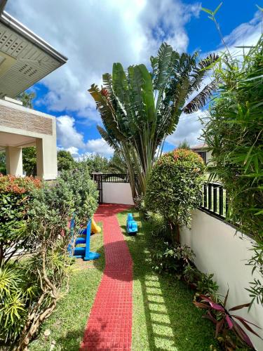 a garden with a red carpet in a yard at Soleil Pines Place Tagaytay in Tagaytay