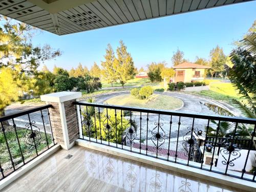 a balcony with a view of a yard at Soleil Pines Place Tagaytay in Tagaytay