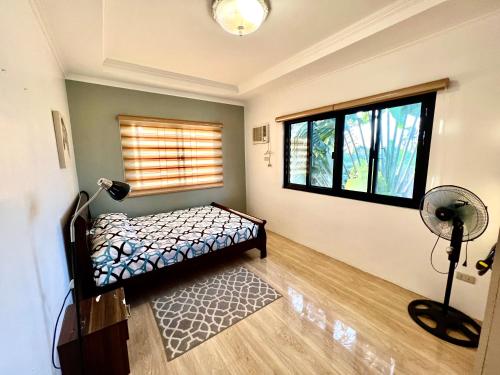 a bedroom with a bed and a window at Sierra Pines Place Tagaytay in Tagaytay