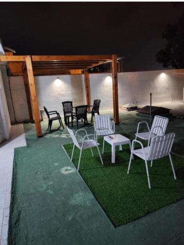 a group of chairs and tables on the grass at Habitacion con baño in Termas de Río Hondo