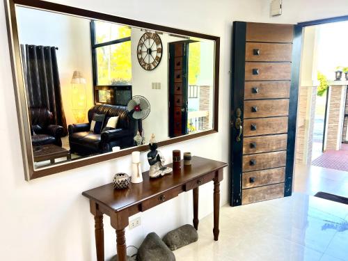 a room with a table and a large mirror at Soleil Pines Place Tagaytay in Tagaytay