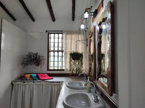 a bathroom with two sinks and a mirror at Habitacion The View in Cali