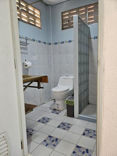 a bathroom with a toilet and a shower at Thai Garden​ Resort​ Kanchanaburi​ in Kanchanaburi City